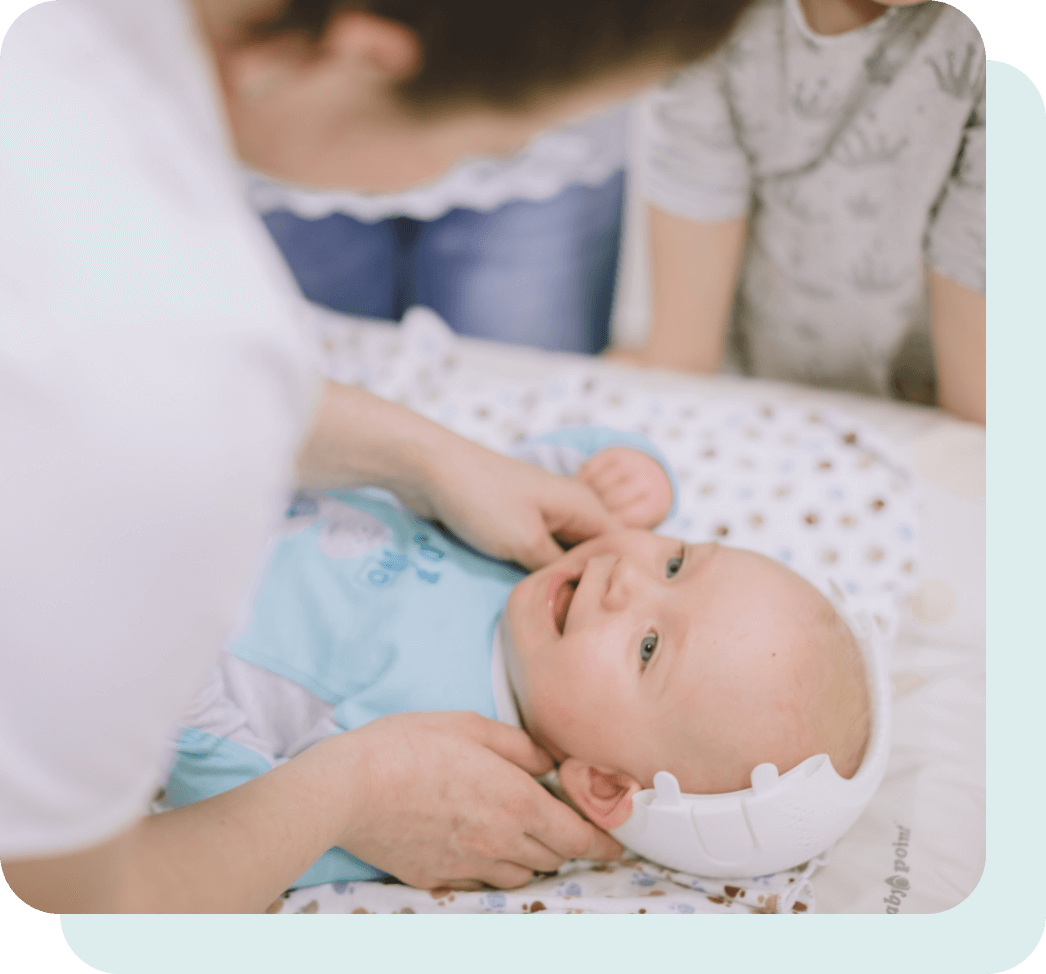 Baby with helmet being fitted