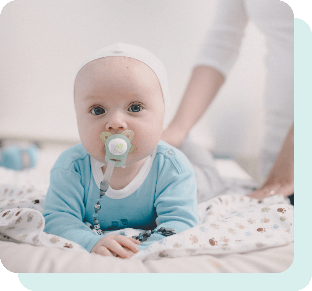 Baby lying on bed